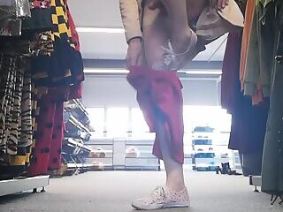 Bella flashing and playing in clothes store